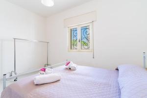 Postel nebo postele na pokoji v ubytování Villa Iris Punta Prosciutto