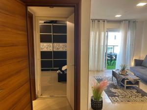 a door leading into a room with a living room at מיני סוויטה לה פלמורה in Eilat +2 photos