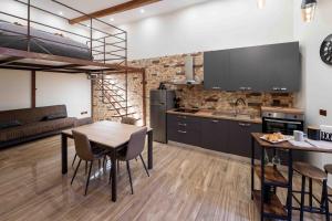 a kitchen and living room with a table and chairs at Casa Zoe in Barletta