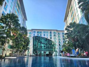 a swimming pool in the middle of a building at Nice apartment in Pattaya Central