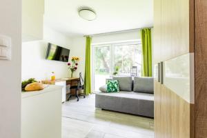 a living room with a couch and a desk at HomeKoko Apartments in Katowice