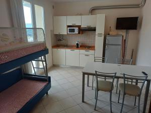 a kitchen with a table and chairs in a room at Residence Ducale in Rimini