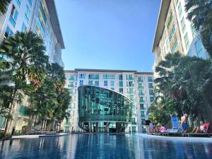 a swimming pool in the middle of a building at Nice studio comfortable in Pattaya Central