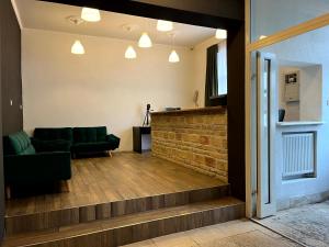 a living room with a couch and a staircase at Hostel Waltz in Bratislava