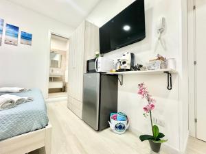 a small kitchen with a black refrigerator in a room at Ale & Andry House in Cefalù