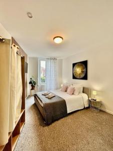 a bedroom with a large bed and a window at Studio 3 Rue Théodore Bac - DABNB in Limoges