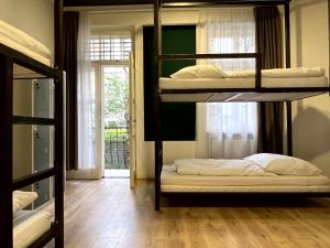 two bunk beds in a room with a window at Hostel Waltz in Bratislava