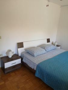 a bedroom with two twin beds and a night stand at Apartma Ester in Lucija