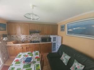 a kitchen with a couch and a table in it at Appartement T2 Le Teich in Le Teich