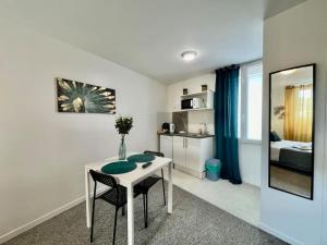 a room with a table and chairs and a bedroom at Studio 5 Rue Théodore Bac - DABNB in Limoges
