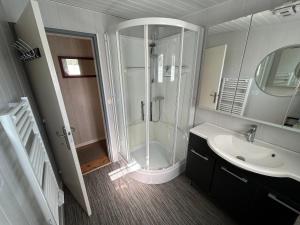 a bathroom with a shower and a sink at Maison MAHECO in Gujan-Mestras