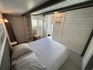 a bedroom with a bed in a small room at Maison MAHECO in Gujan-Mestras