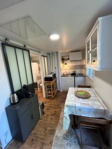 a kitchen with a table in the middle of a room at Maison MAHECO in Gujan-Mestras
