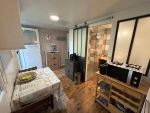 a room with a bathroom with a bed and a television at Maison MAHECO in Gujan-Mestras