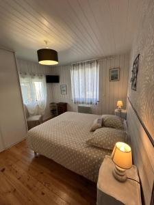a bedroom with a large bed in a room at Maison MAHECO in Gujan-Mestras