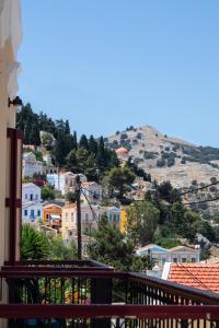 a view of a town from the balcony of a house at Duchess Harbour View in Symi
