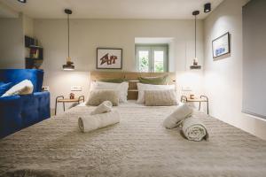 a large bed in a bedroom with two pillows on it at MASTER ROSE STUDIO in old town in Nafplio +32 photos