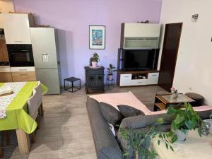 a living room with a couch and a tv at Apartment Teo & Leon in Novi Vinodolski