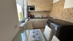 a kitchen with a table and a counter top at Apartament Rodzinny Nad Morzem, Gdynia in Gdynia