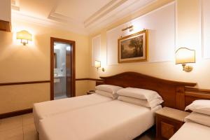 Postel nebo postele na pokoji v ubytování Hotel Hiberia