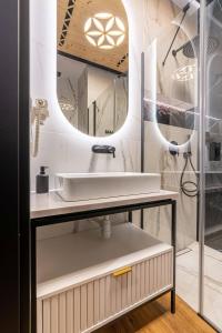 a bathroom with a sink and a mirror at Piaseckiego Residence SPA in Zakopane +56 photos