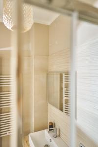 a bathroom with a sink and a mirror at Vista Apartment Bardolino in Bardolino +38 photos