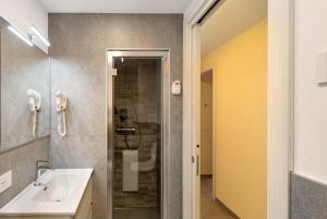 a bathroom with a sink and a shower at A Due Passi Rosso in Livigno +15 photos