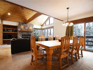 a dining room with a wooden table and chairs at 61 Jabberwocky Home by Stay Winter Park in Fraser
