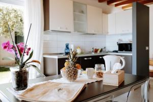 a kitchen with a table with fruits and flowers on it at Residence San Carlo in Gargnano +10 photos