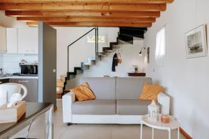 a living room with a couch and a staircase at Residence San Carlo in Gargnano
