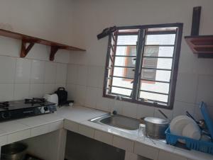 a kitchen with a sink and a window at Tembo village in Watamu