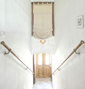 
a stairway leading up to a room with a white wall at Casa Beleza do Sul in Tavira
