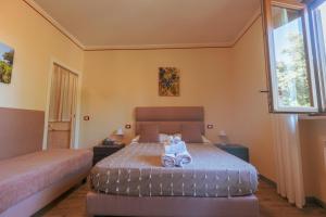 Postel nebo postele na pokoji v ubytování Agriturismo Rascioni & Cecconello