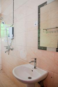 a bathroom with a sink and a mirror at GULOBA Suites in Kampala