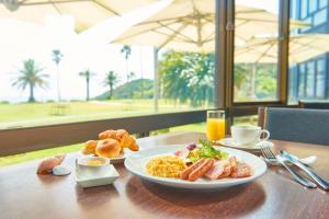 a table with a plate of breakfast food on it at Shimoda Tokyu Hotel in Shimoda