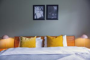 a bedroom with a bed with two pictures on the wall at Titisee Haus an der Sonne by Kuckucksnester in Titisee-Neustadt