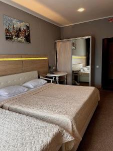 a hotel room with two beds and a table at Київські Ночі in Kyiv