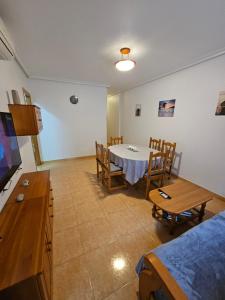 a room with a table and chairs and a tv at Casa Aleks Lo Pagan in San Pedro del Pinatar
