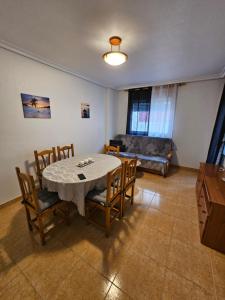 a living room with a table and chairs and a couch at Casa Aleks Lo Pagan in San Pedro del Pinatar