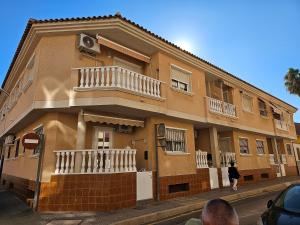 a building with a balcony on the side of it at Casa Aleks Lo Pagan in San Pedro del Pinatar