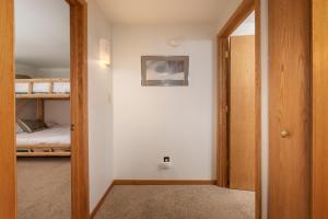 een gang met een deur die leidt naar een slaapkamer met een stapelbed bij Beaver Village Unit #0514 in Winter Park +20 foto's