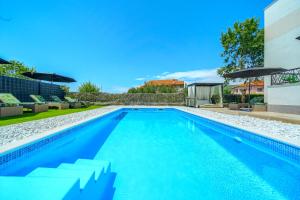 a swimming pool in the backyard of a house at Luxury Villa Nikoma with heated pool and whirlpool in Dicmo