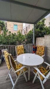 a white table and two chairs on a deck at Vititta Appartamenti in Trapani