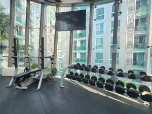 a room with a gym with a lot of weights at Unique studio in town in Pattaya Central