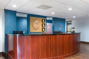 an office lobby with a reception desk and a sign on the wall at Comfort Suites Atlanta Airport in Forest Park