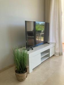 a flat screen tv sitting on a white entertainment center at Casa lagoon & pool, Alcazaba by Casa del sol HR in Casares