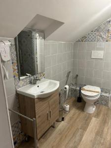 a bathroom with a sink and a toilet at FIESCHI Rooms in Genoa +41 photos
