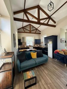 a living room with a blue couch and a kitchen at Railway Cottage in Cork