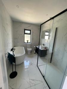 a bathroom with a tub and a toilet and a sink at Innis Breeze - Between Murvagh & Rossnowlagh Beaches in Donegal +19 photos