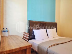 Voodi või voodid majutusasutuse Mutiara Residence Near Simpang Lima Mitra RedDoorz toas